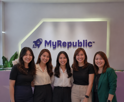 The MyRepublic Group HR team standing together in front of the MyRepublic sign at the Singapore office.
